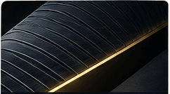 A dark, refined material with a precise gold edge